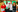 Four people smiling to the camera. Two of them are holding award trophies that say 'British Training Awards'.