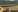 A controlled cluster bomb explosion in a rice field in Laos